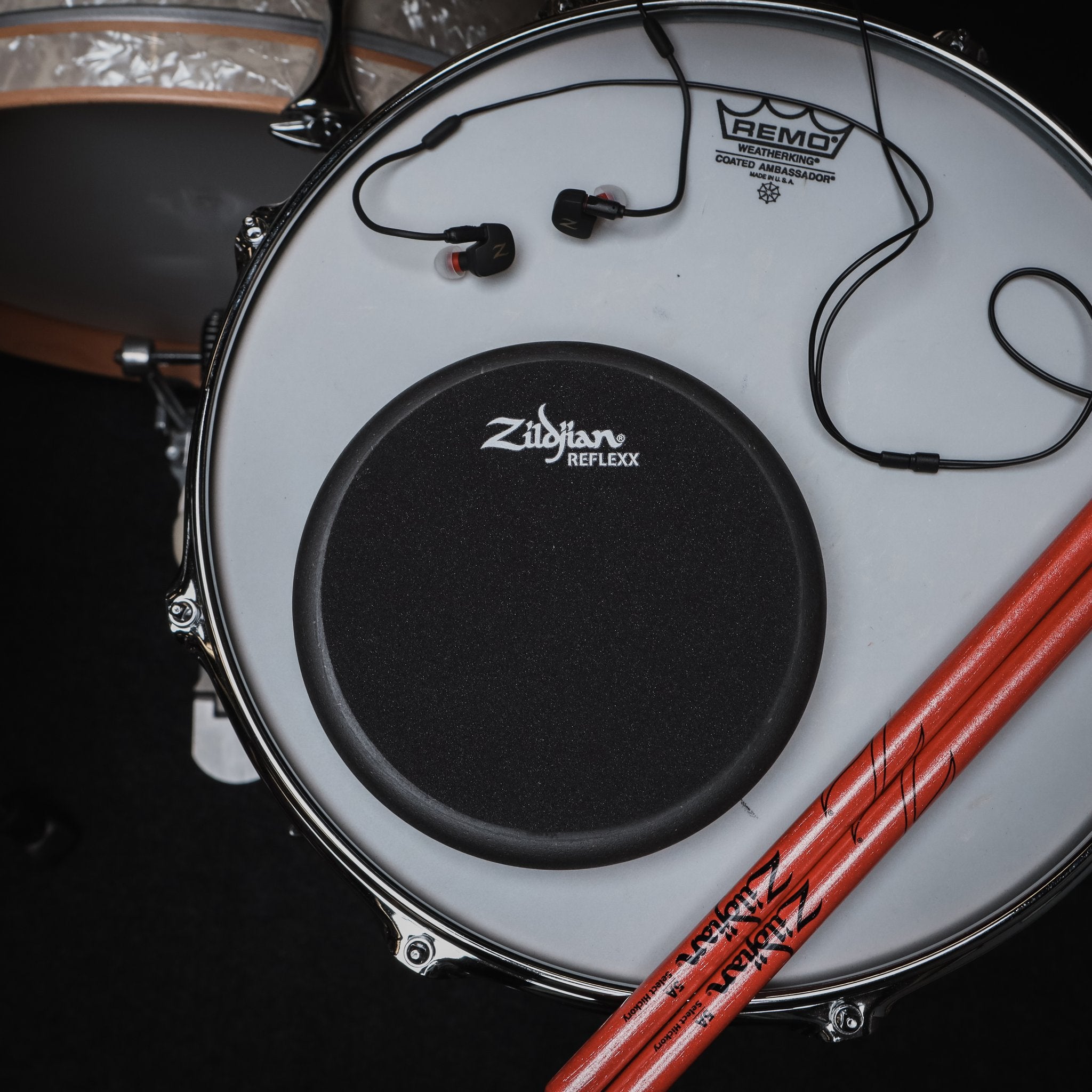 Zildjian Reflexx Workout Pad 6" Sitting on Drum with Drumsticks